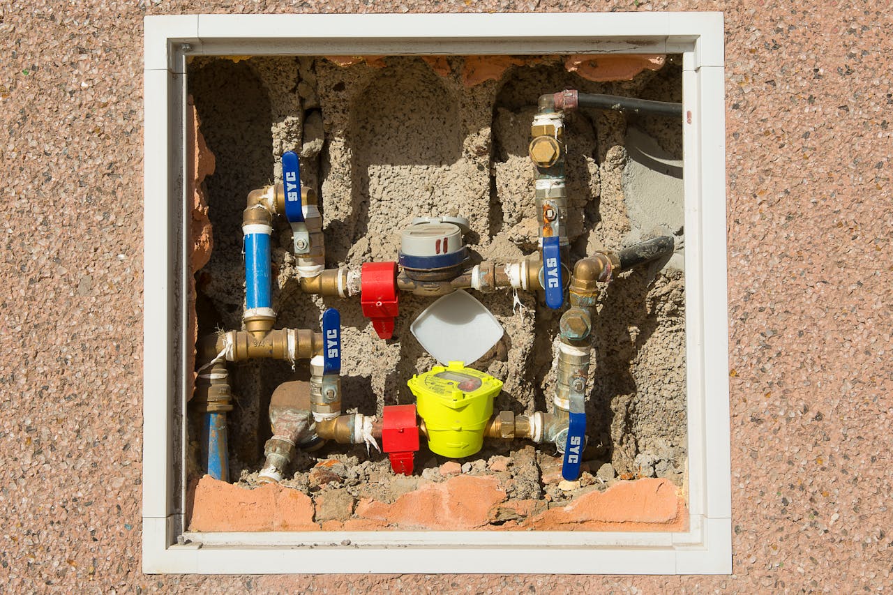 The Art of Drawing Readers In: Your attractive post title goes here Detailed view of a complex water meter setup embedded in a concrete wall.